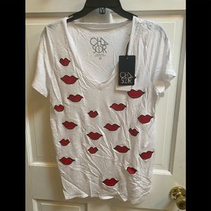 White v neck tee with red hearts.